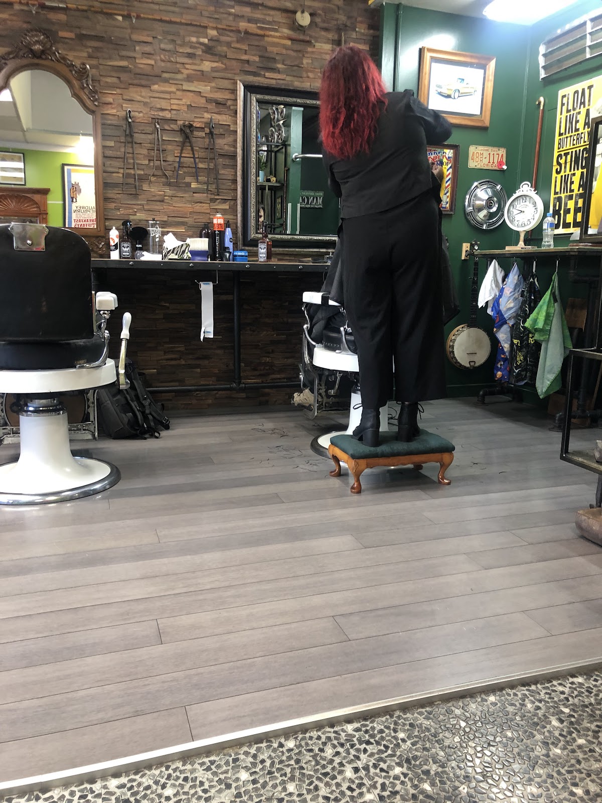 Barber at work beside the vintage decor and posters