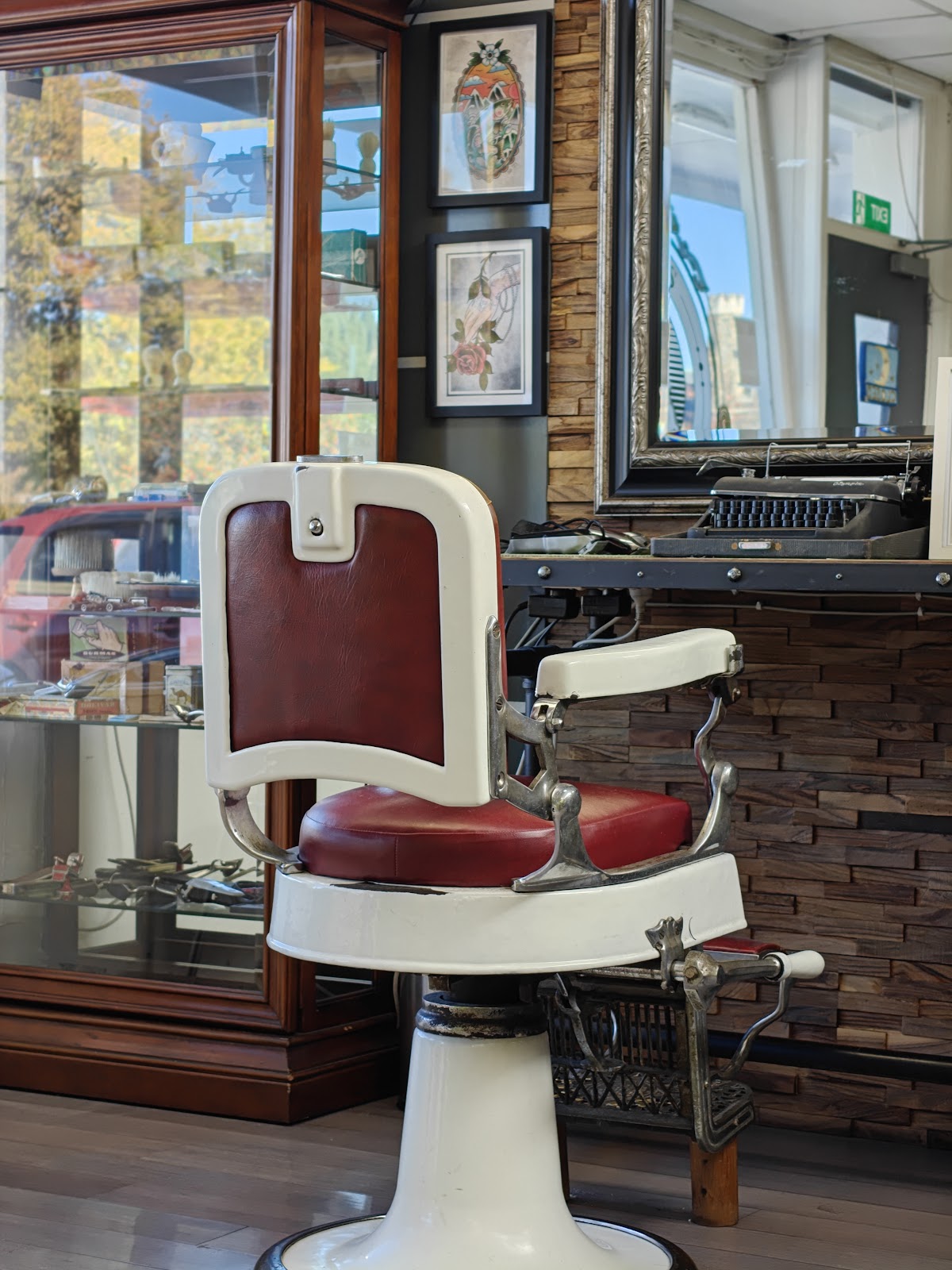 Restored antique barber chair with red leather at Old Dogs Barbershop